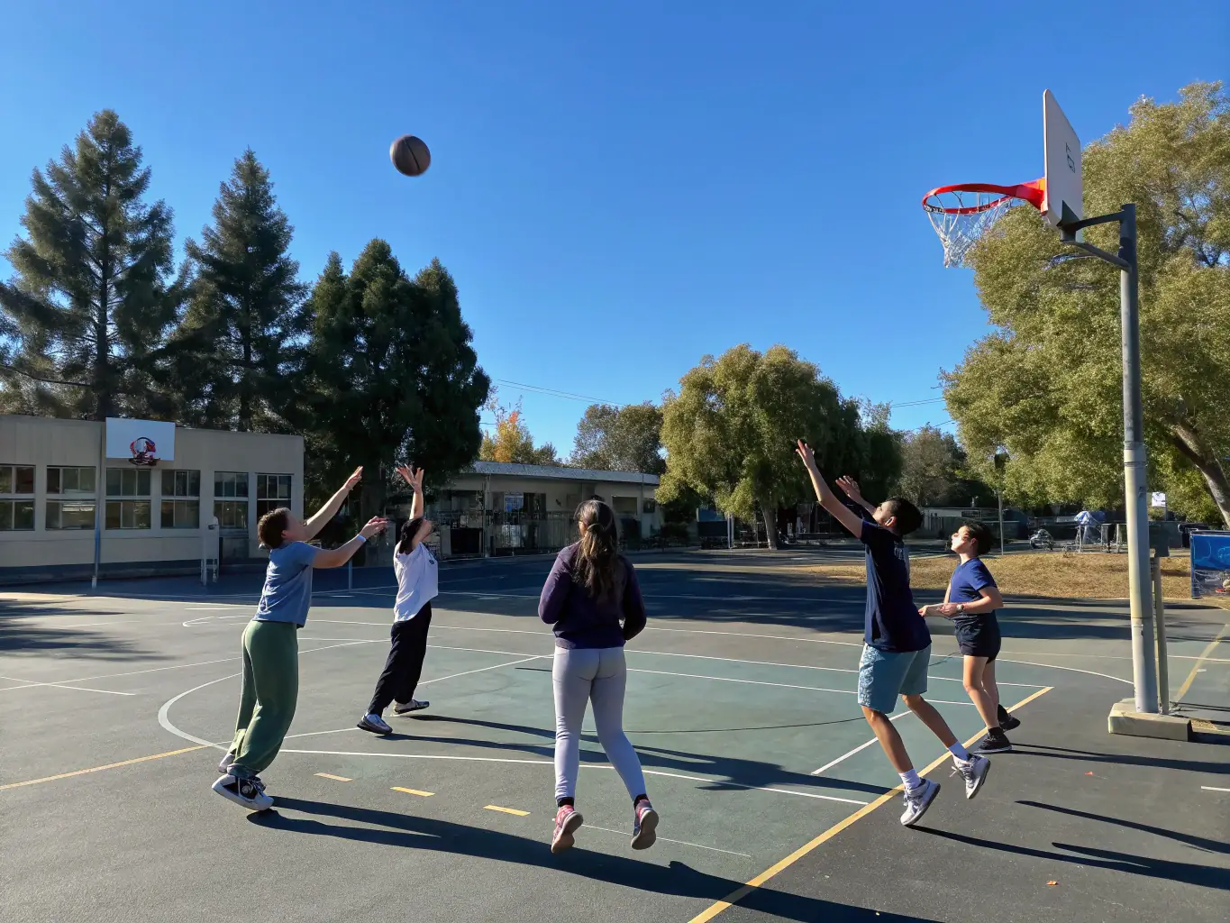 A dynamic image of students engaged in a basketball game, highlighting the fast-paced action and competitive spirit of the sport.